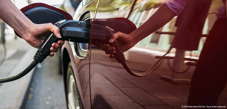AddÉnergie - A person recharging his electric vehicle AddÉnergie - Photo of a person recharging his electric vehicle